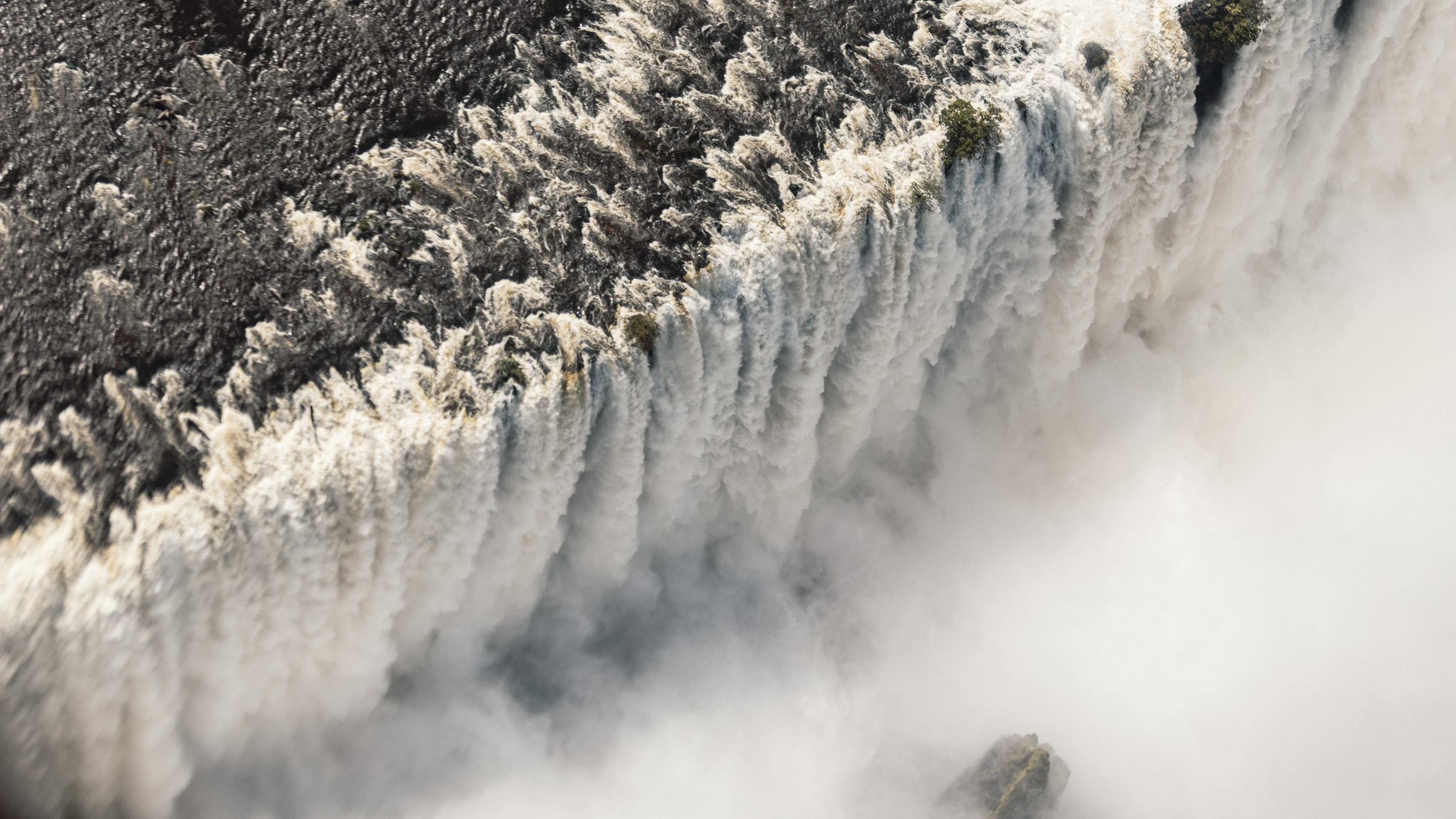 Helicopter view of the Zambezi river spilling into the Victoria Falls gorge