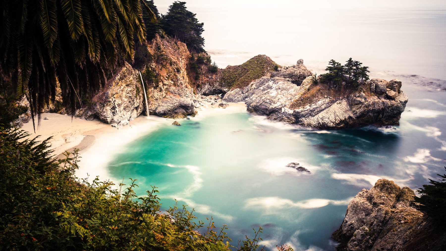 McWay Falls and its cove framed by cypress on the Big Sur coast