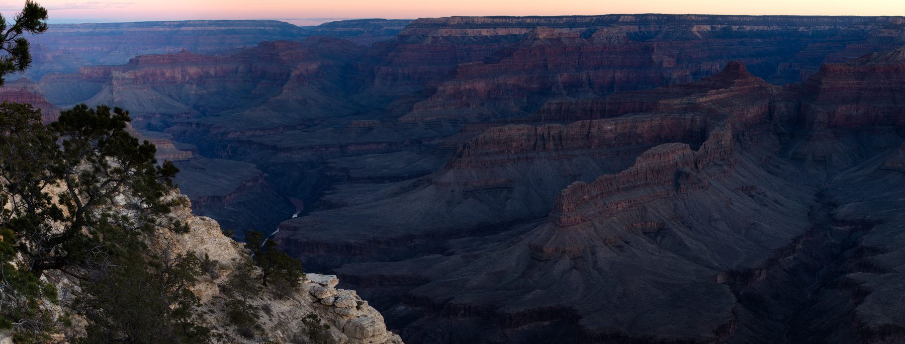 A wide panoramic of the Grand Canyon in flat shadowed light