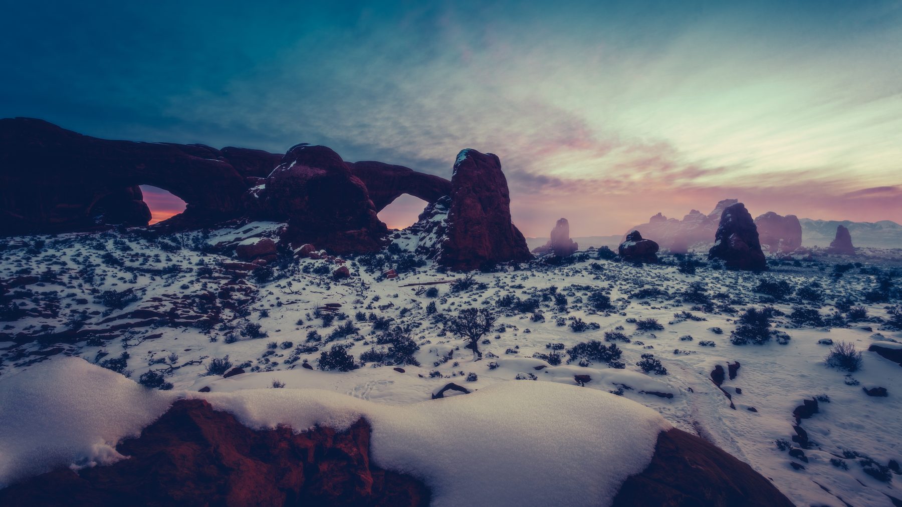 The North and South Windows under fresh snow and a cold teal sky