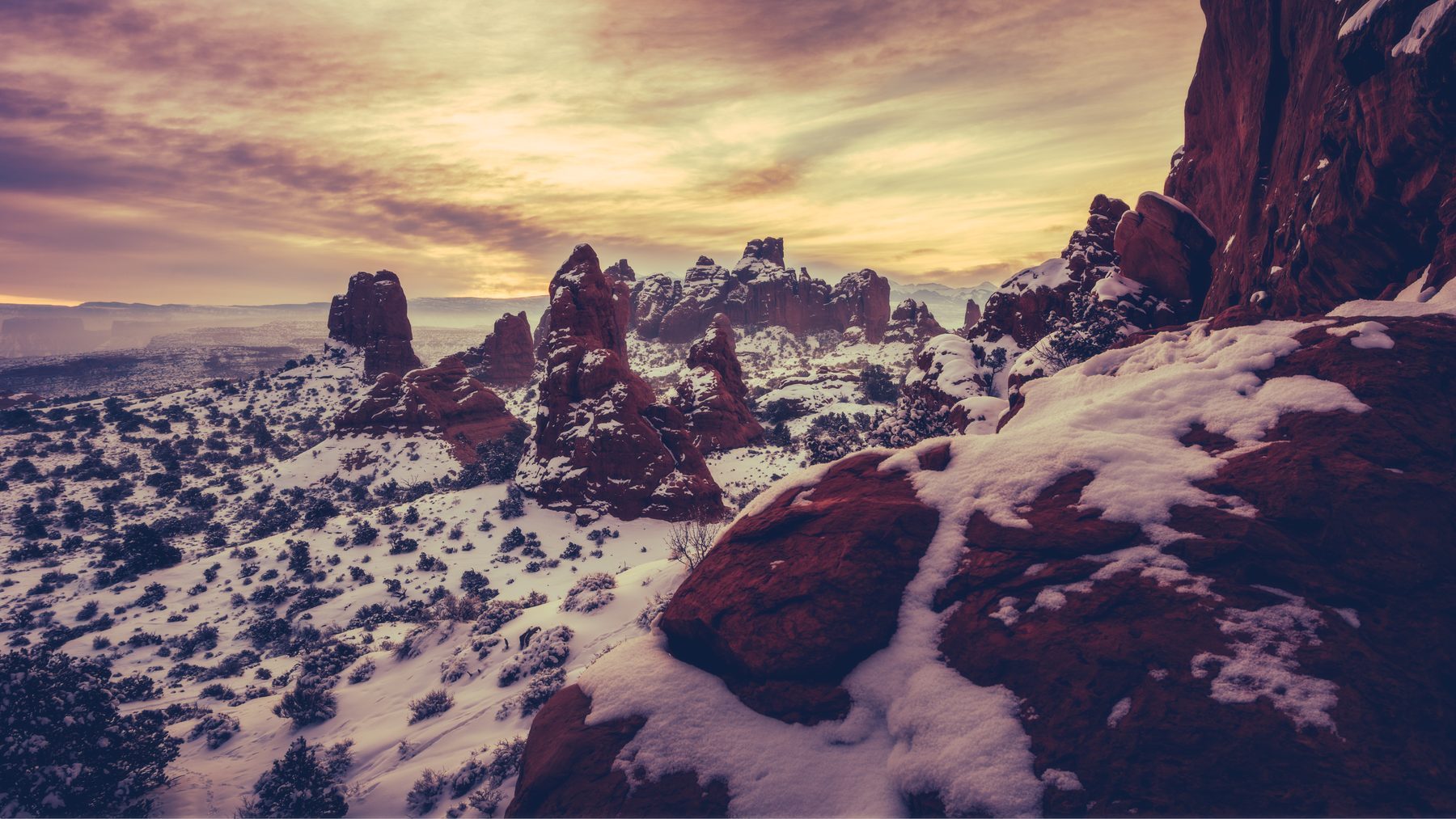 Snow-covered sandstone fins catching the last warm light of the day